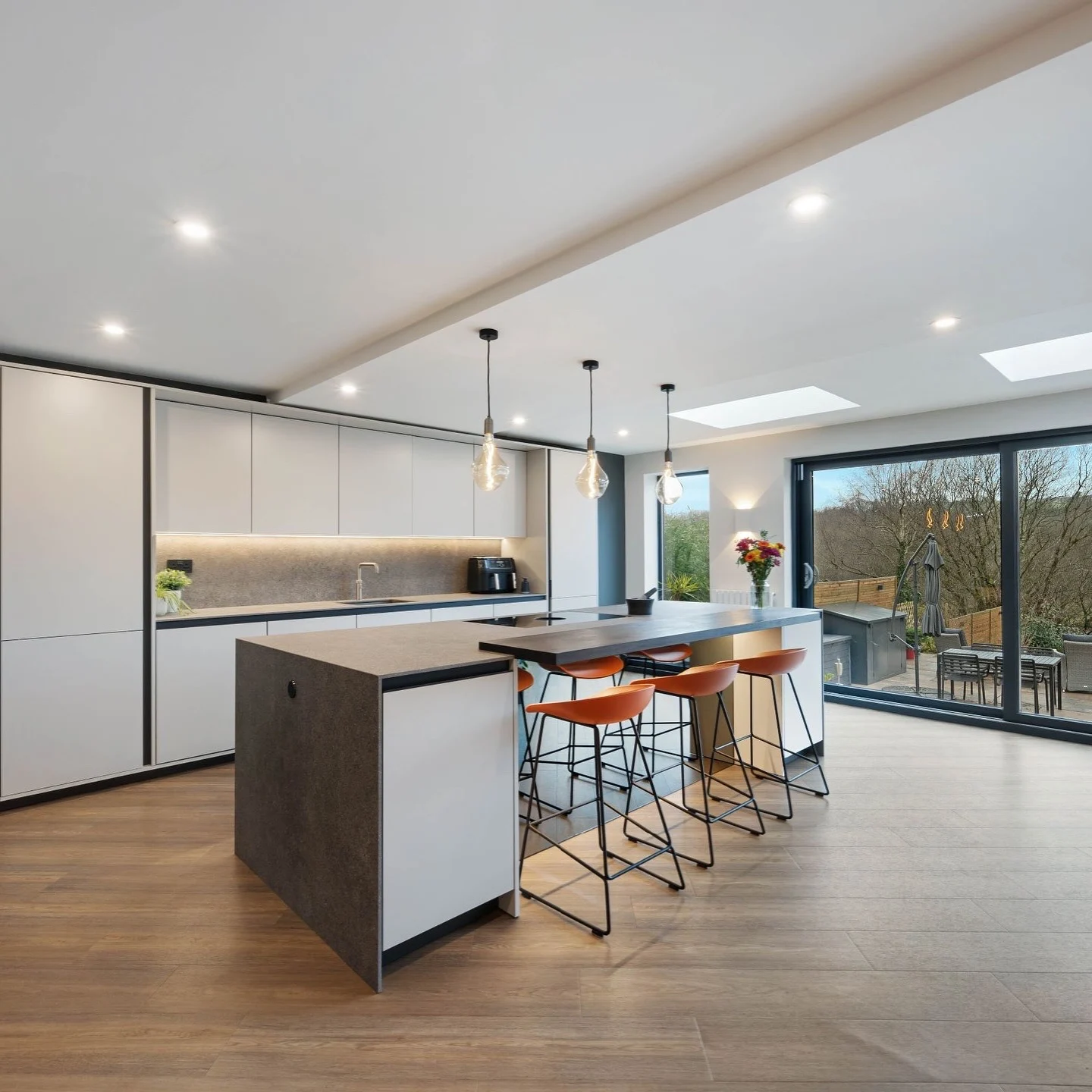 Completed contemporary kitchen with rooflight and island seating